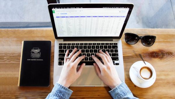 married woman working on a spreadsheet on a computer