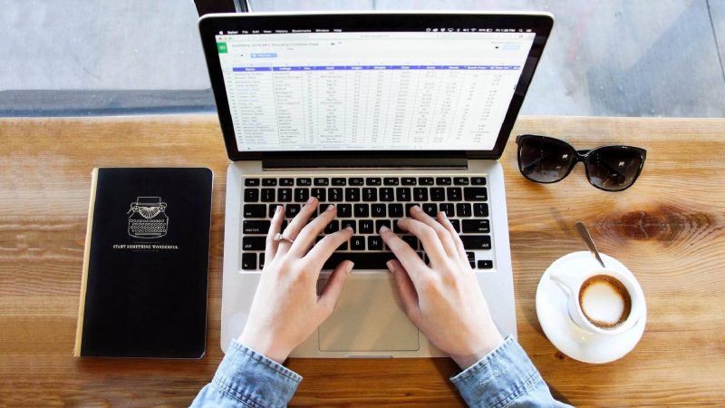 married woman working on a spreadsheet on a computer