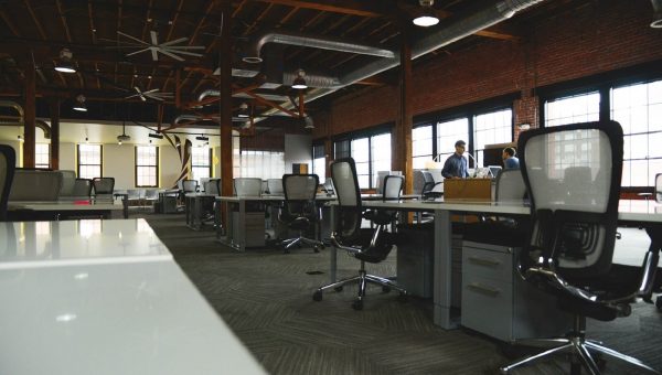 Nearly empty office space with two men