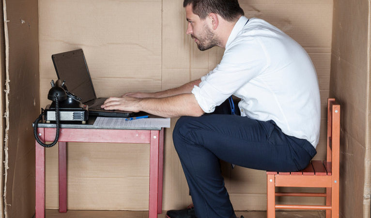 businessman in small office working on laptop