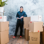 man standing between cardboard boxes
