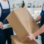 two movers wrapping box