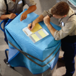 two persons listing on clipboard paper