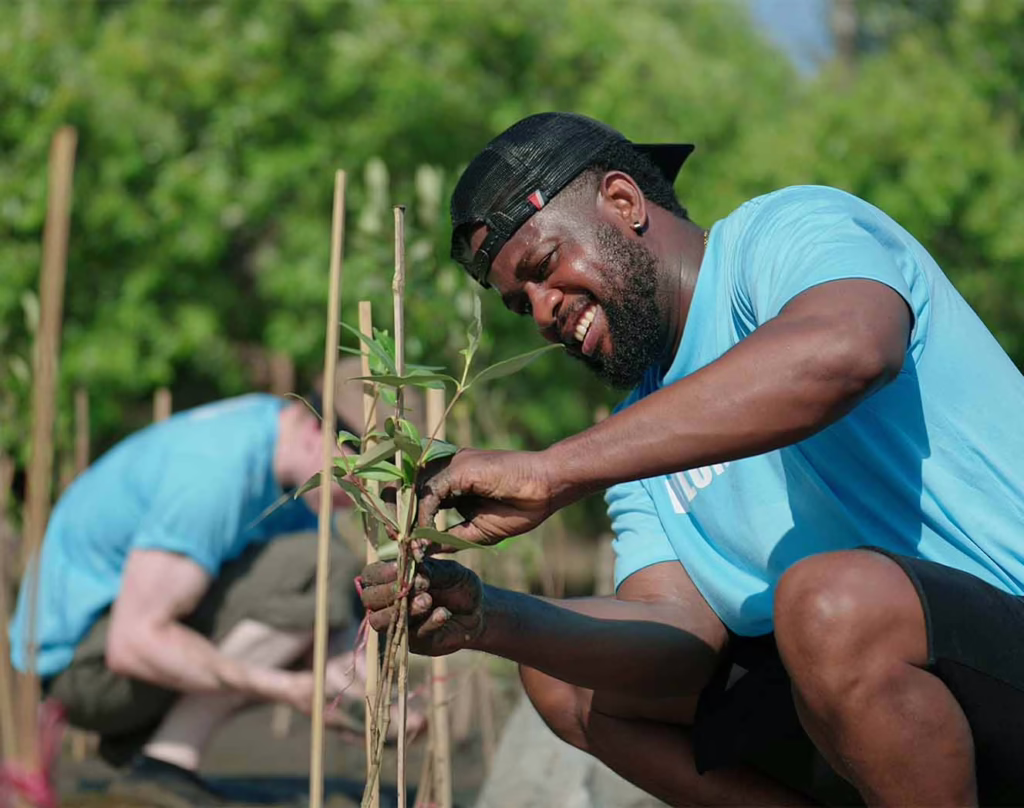 Apple moving company employee helping neighbors with garden